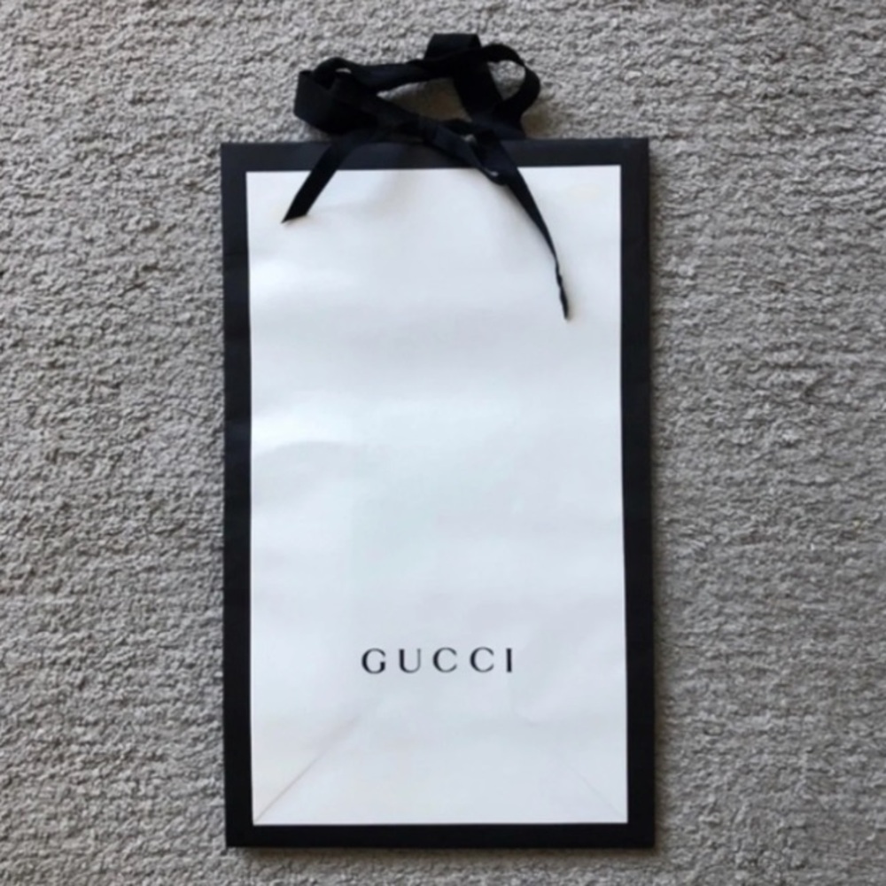 Authentic Gucci Paper Bag. White with a black trim and black Gucci Logo.